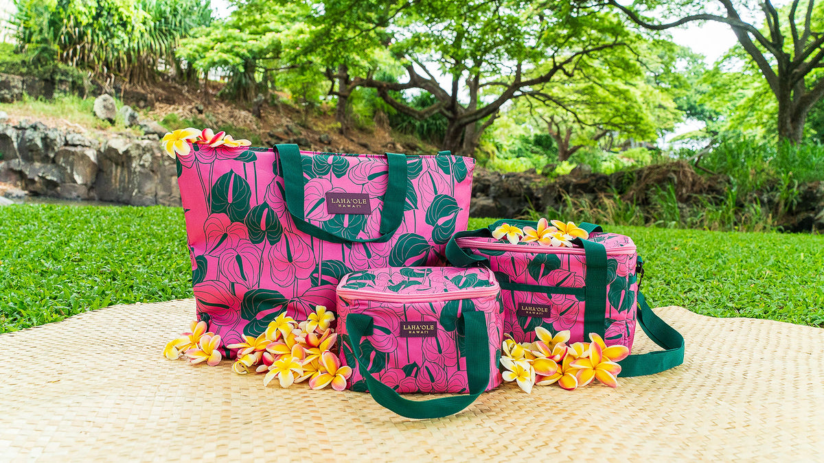 Three-piece pink Anthurium cooler bag set on a picnic mat
